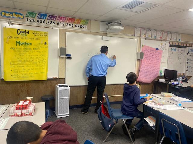 Superintendent Dr. James Q. Hammond teaching a class of OMSD students for the day